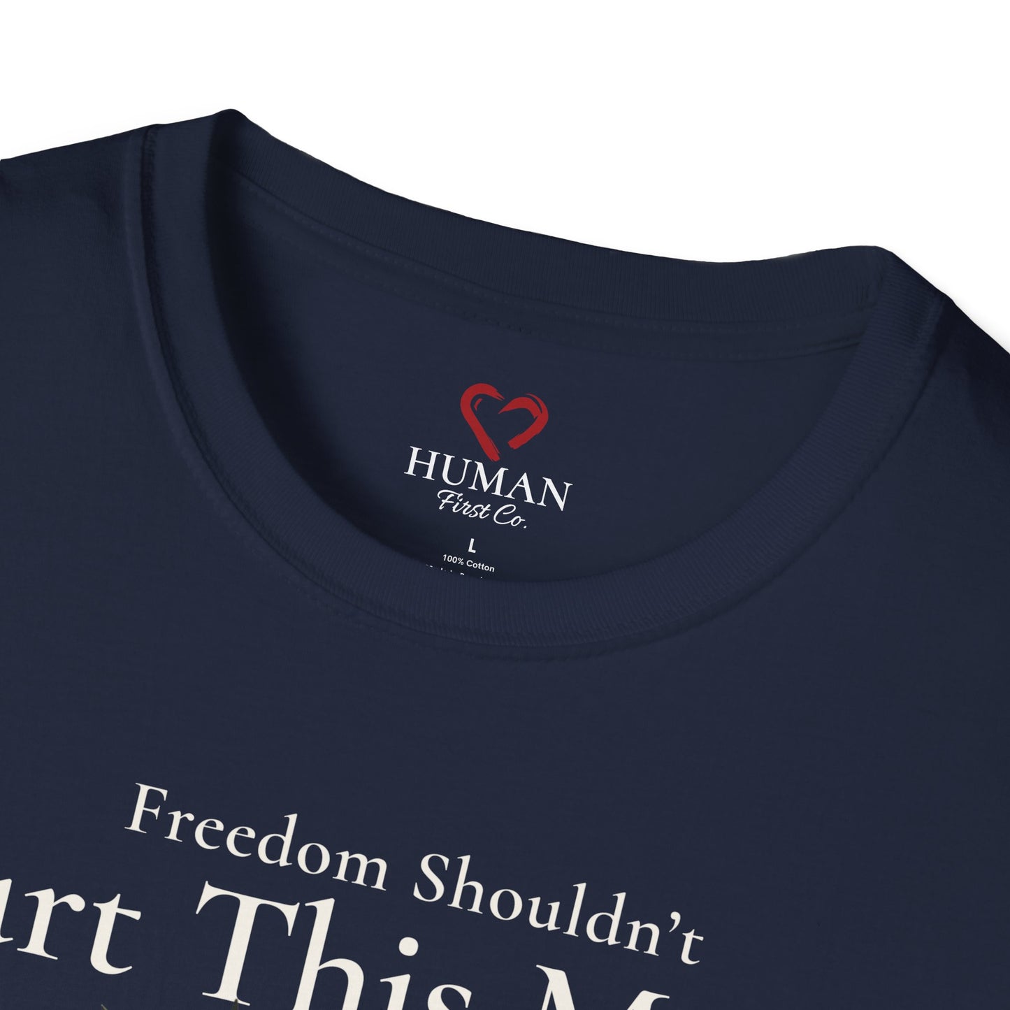 Close-up collar view of Human First Co. humanitarian t-shirt showing branded neck label and garment details.