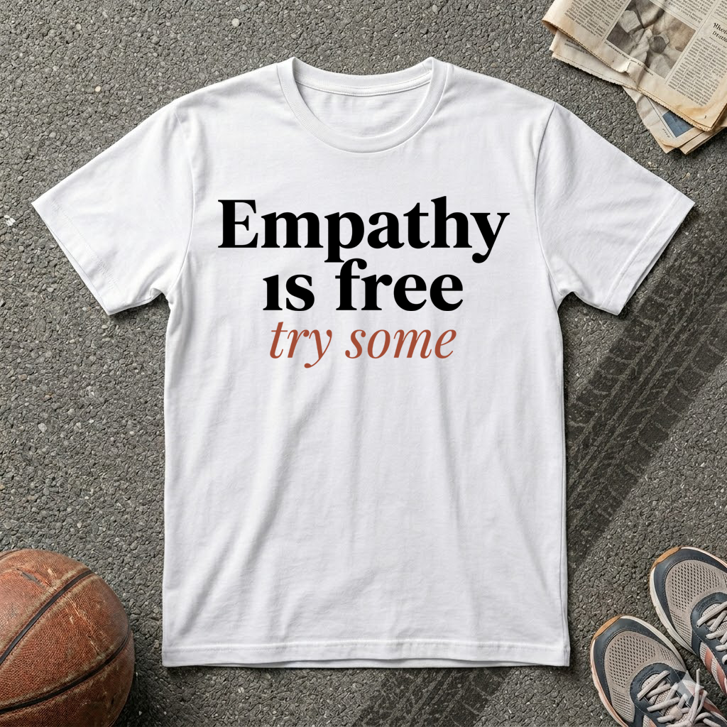 White humanitarian t-shirt featuring the message "Empathy Is Free" in minimalist editorial typography, promoting understanding, compassion, and human connection.