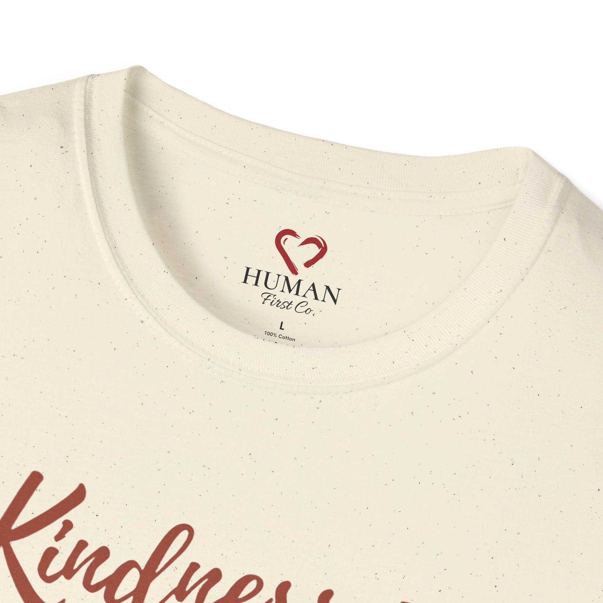 Close-up collar view of Human First Co. humanitarian t-shirt showing branded neck label and garment details.