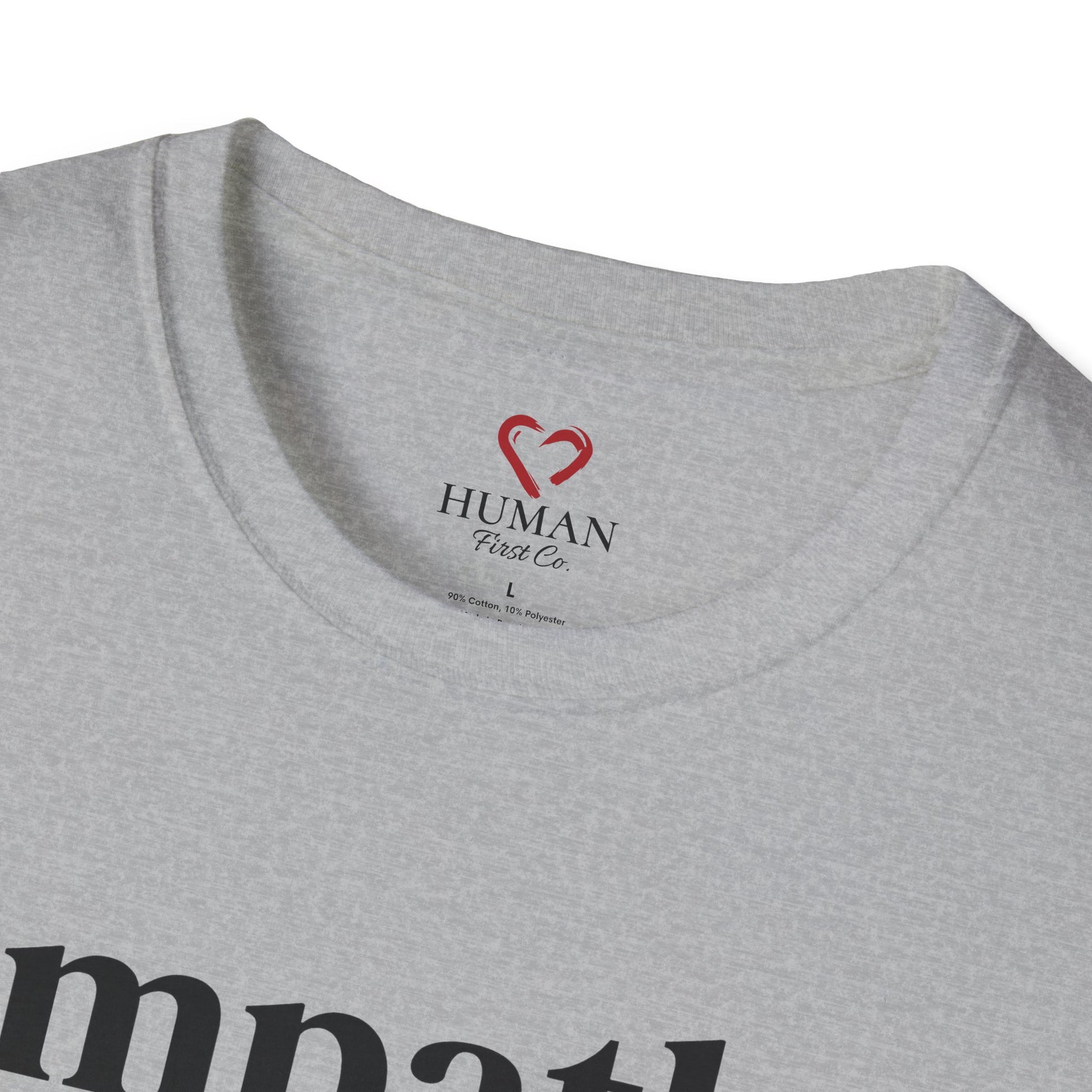 Close-up collar view of Human First Co. humanitarian t-shirt showing branded neck label and garment details.